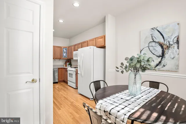 a kitchen with stainless steel appliances granite countertop a stove a sink dishwasher and a microwave oven with large wooden cabinets