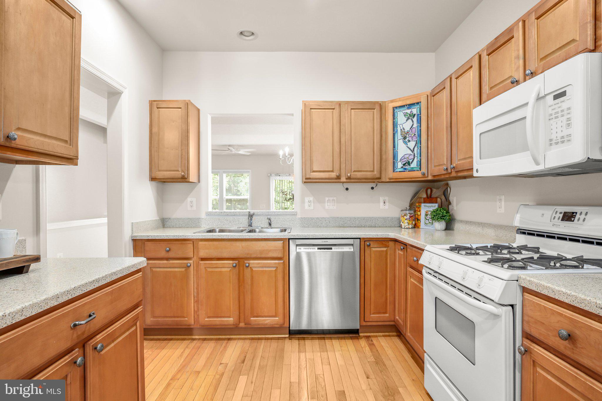 14 Sugargrove Court Fredericksburg, VA 22406 - Photo 10 of 63 a kitchen with stainless steel appliances granite countertop a stove a sink dishwasher and a microwave oven with large wooden cabinets