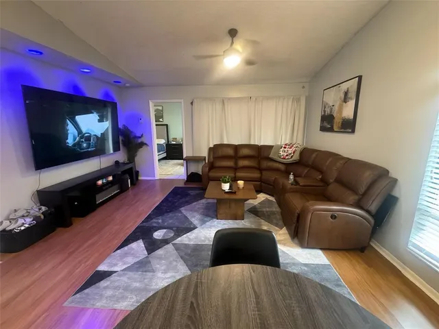 a living room with furniture flat screen tv and fireplace