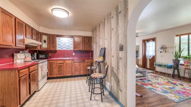 a kitchen with stainless steel appliances granite countertop a refrigerator and a stove top oven
