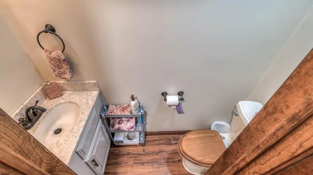 a bathroom with a sink mirror and toilet