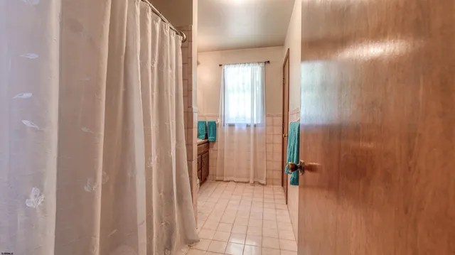 a view of a bathroom from a hallway