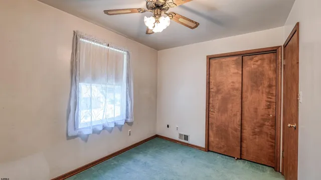 an empty room with windows and closet