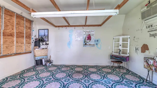 a bedroom with furniture and a window