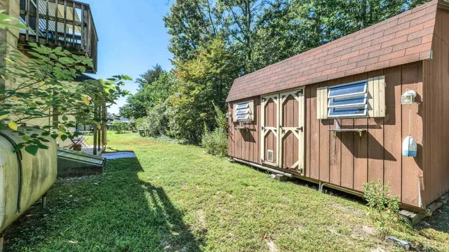 a view of house with backyard and garden