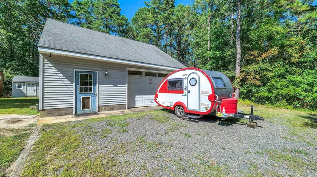 a view of backyard with tub and entertaining space