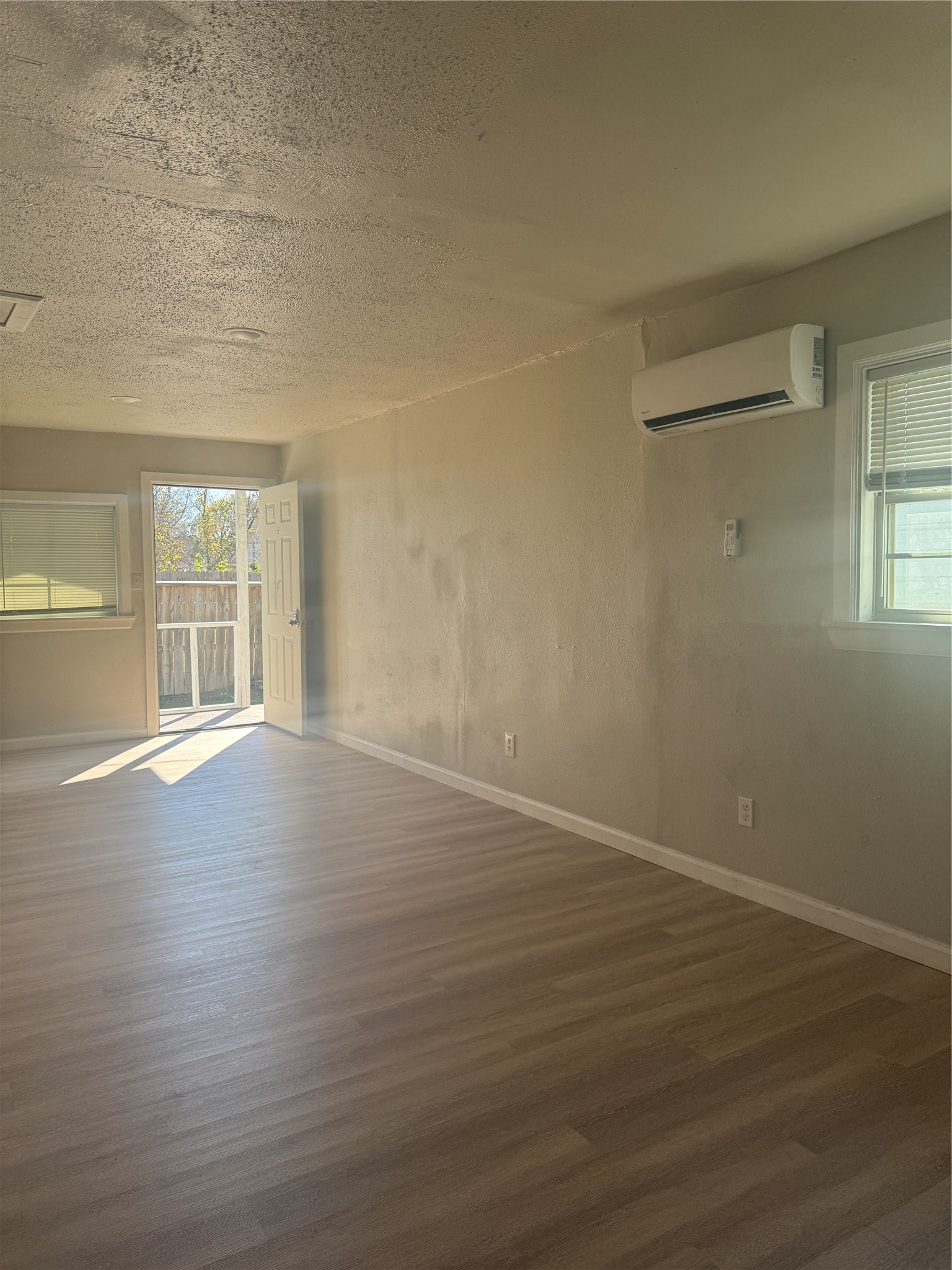 8510 Safeguard Street, Unit 3 Houston, TX 77051 - Photo 12 of 13 wooden floor in an empty room with a window