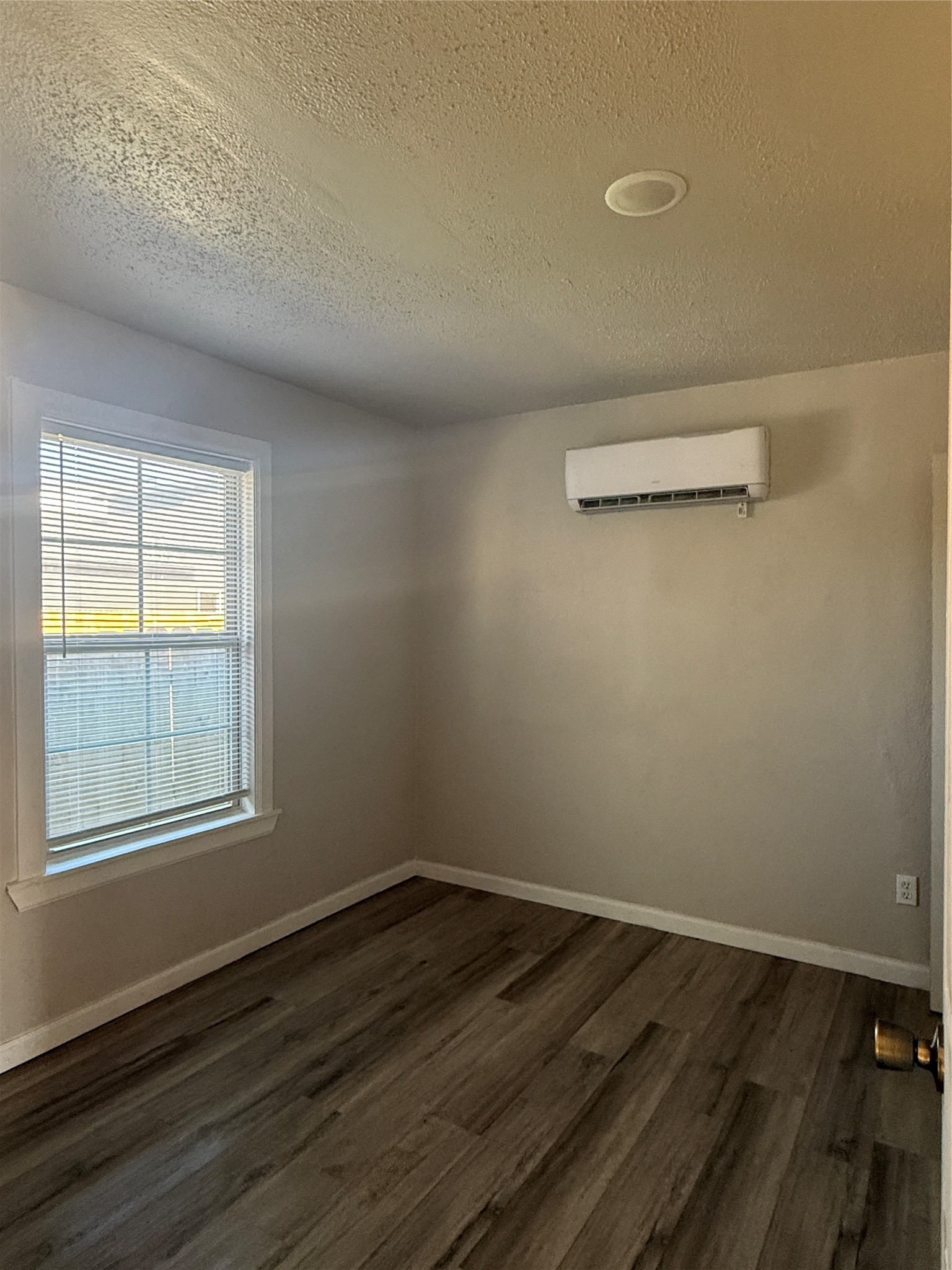 8510 Safeguard Street, Unit 3 Houston, TX 77051 - Photo 8 of 13 an empty room with wooden floor and windows