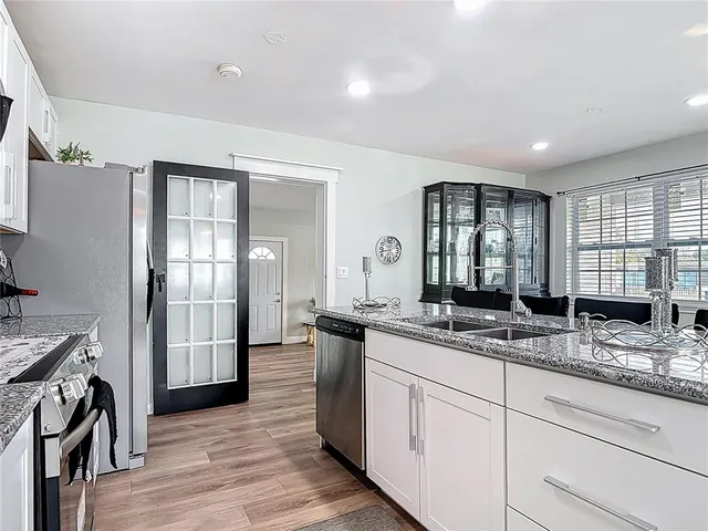 a kitchen with stainless steel appliances granite countertop a sink stove and refrigerator