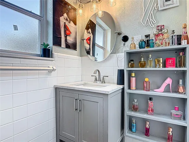 a bathroom with a sink and a shelf
