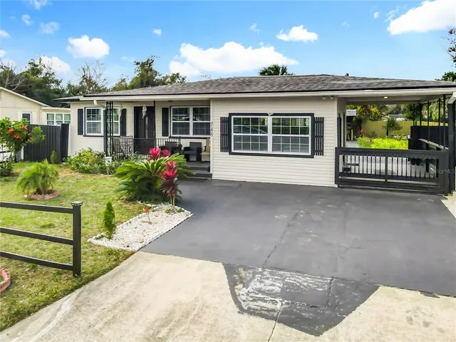 a front view of a house with a yard table and chairs