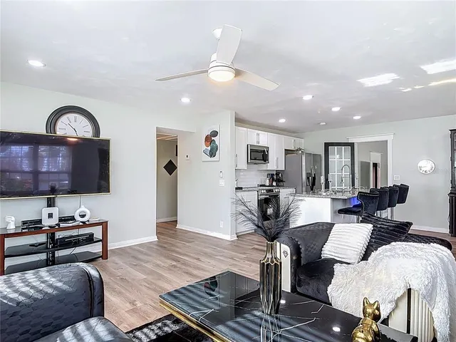 a living room with furniture and wooden floor