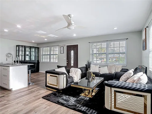 a living room with furniture and wooden floor