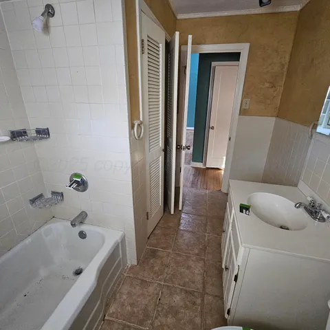 a bathroom with a tub and sink