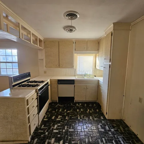 an empty room with a ceiling fan and window