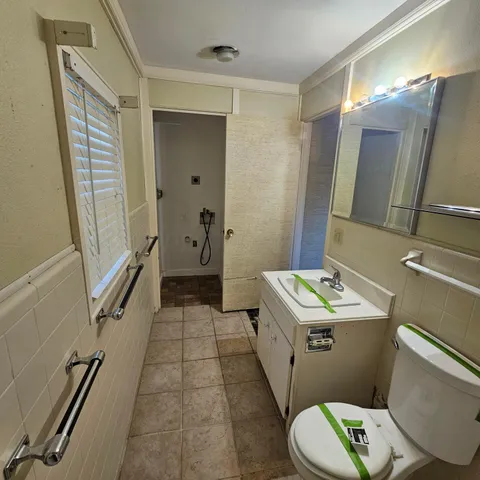 a kitchen with a stove and white cabinets