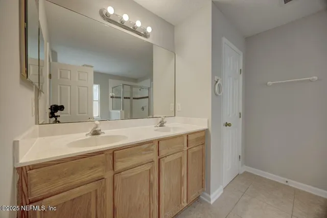 a bathroom with 2 sink and a mirror