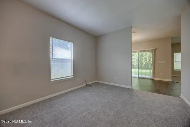 a kitchen with white cabinets and appliances