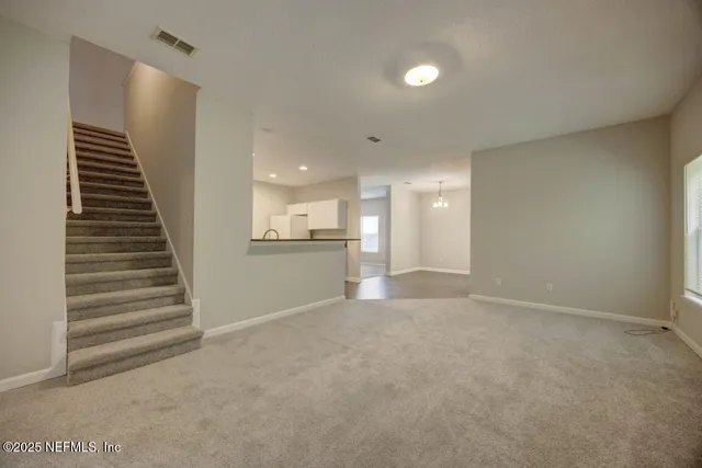 a kitchen with granite countertop a sink and a stove top oven