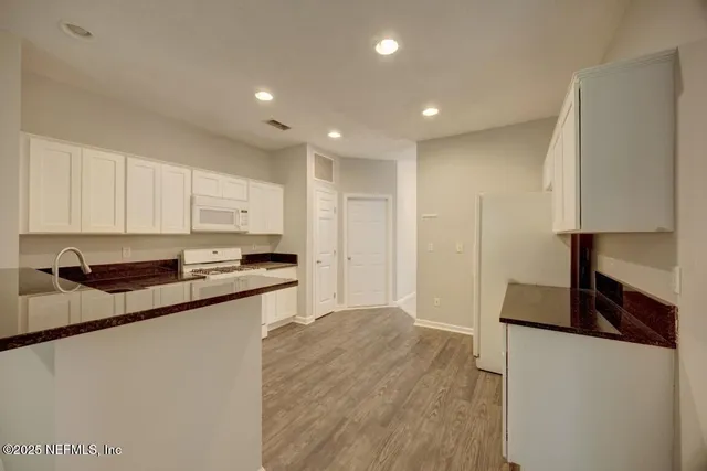 a view of livingroom and an empty room