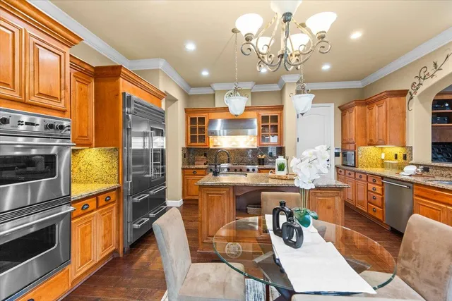 a kitchen with stainless steel appliances granite countertop a stove and cabinets