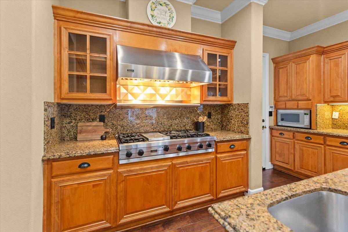 3168 Hutton Place Tracy, CA 95377 - Photo 17 of 94 a kitchen with stainless steel appliances granite countertop a stove and cabinets