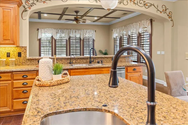 a living room with couches and pool table with wooden floor