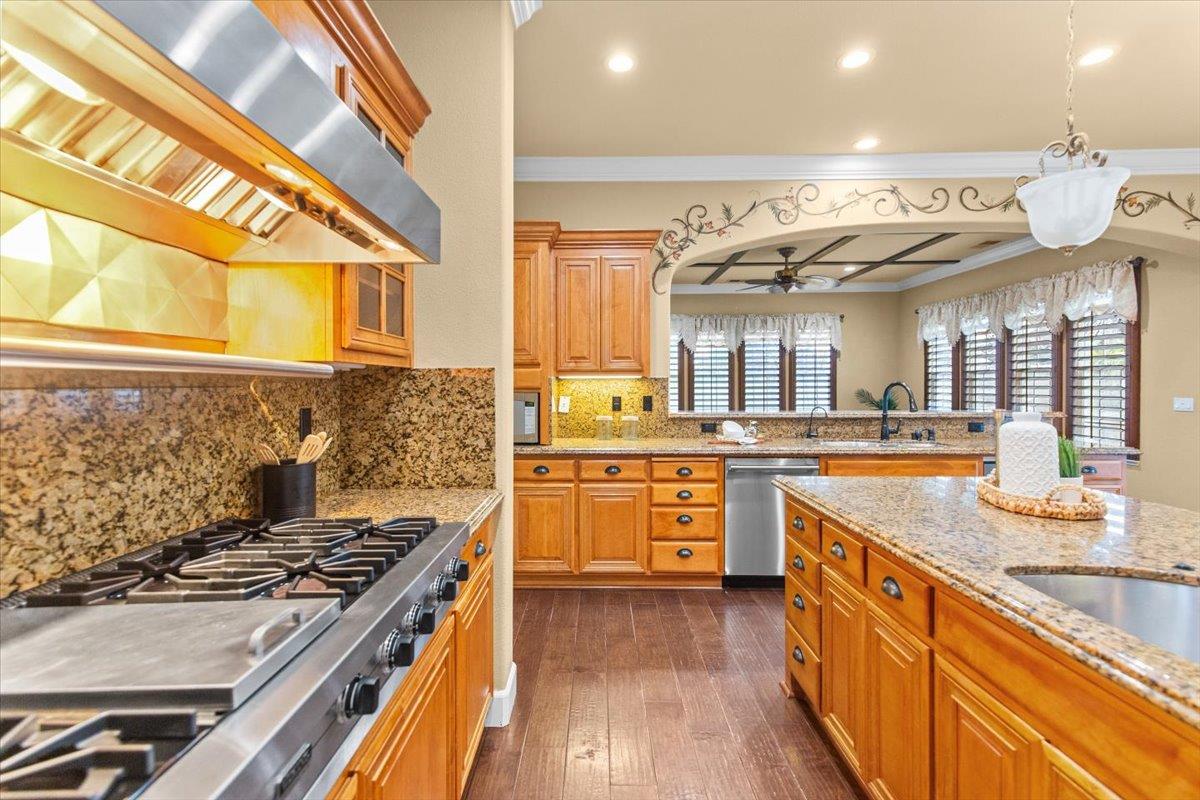 3168 Hutton Place Tracy, CA 95377 - Photo 20 of 94 a kitchen with stainless steel appliances granite countertop a stove and a sink
