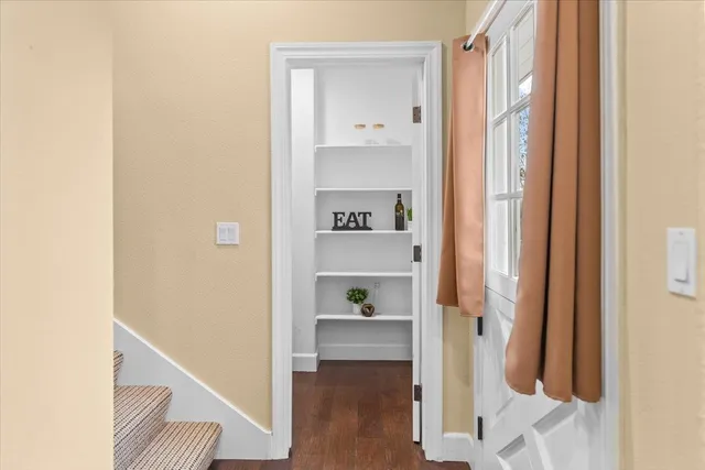 a kitchen with stainless steel appliances granite countertop a stove and a wooden floor