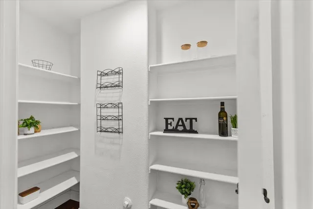 a bedroom with bed and wooden floor