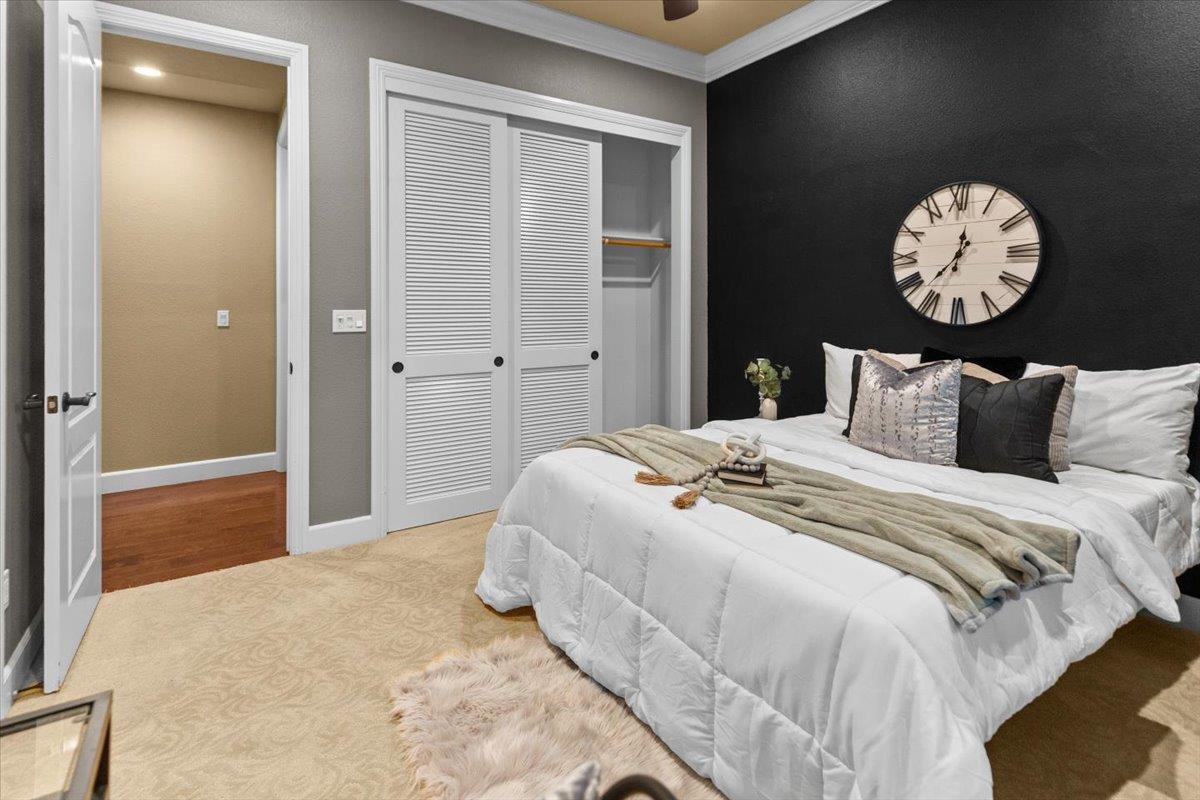 3168 Hutton Place Tracy, CA 95377 - Photo 39 of 94 a bedroom with a bed and a chandelier