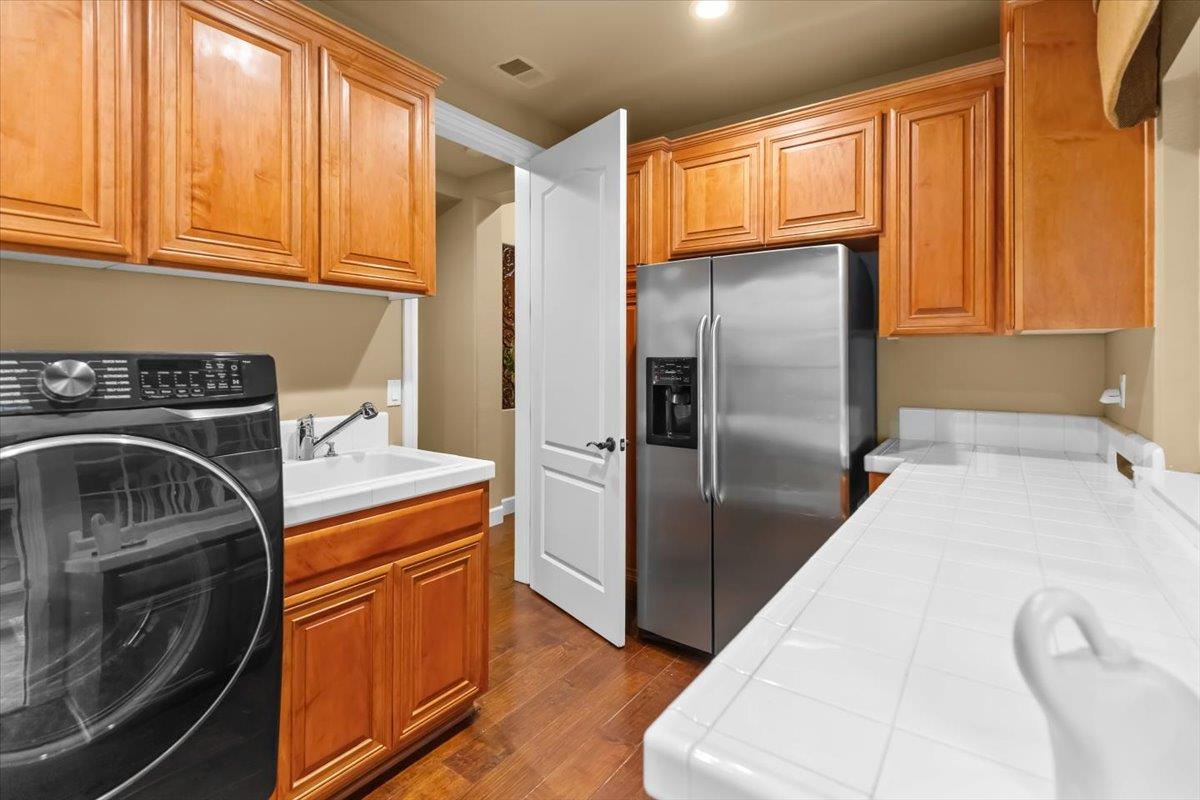 3168 Hutton Place Tracy, CA 95377 - Photo 56 of 94 a kitchen with stainless steel appliances granite countertop a refrigerator a stove and a sink with cabinets