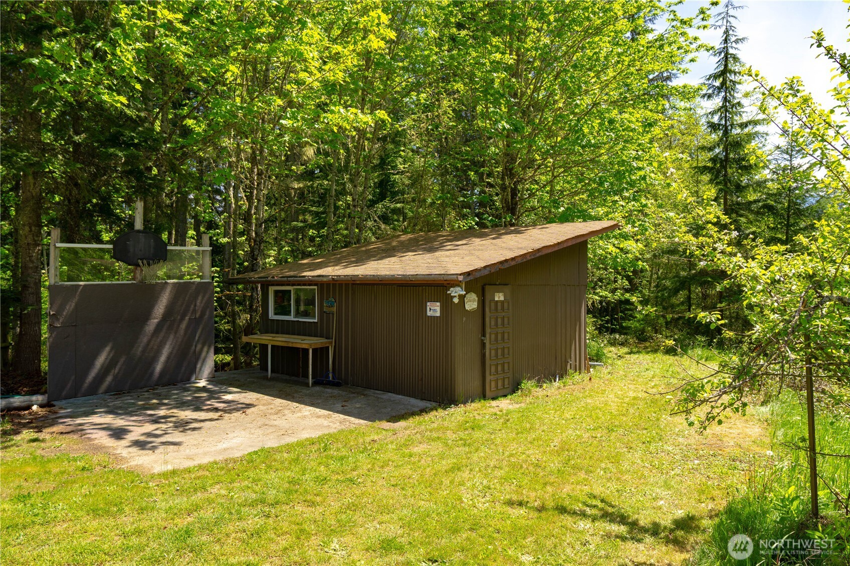 89 Slab Camp Road Sequim, WA 98382 - Photo 36 of 40 a backyard of a house with a large tree
