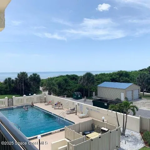 a view of a patio with a table and chairs