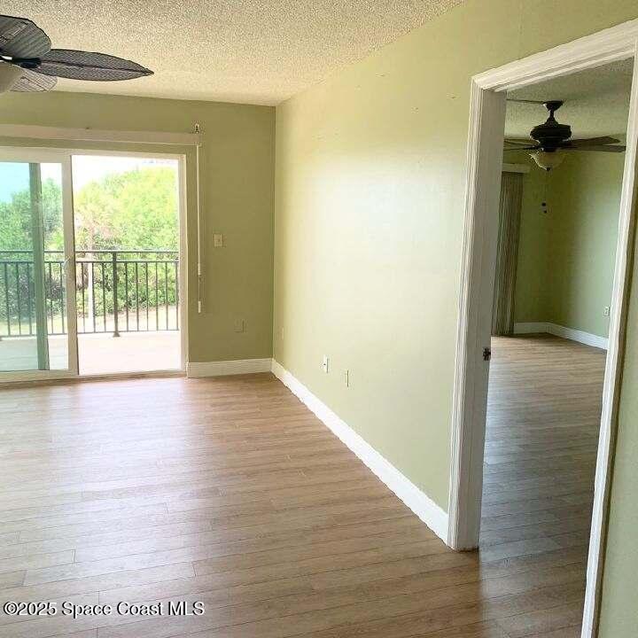 3060 North Atlantic Avenue, Unit 308 Cocoa Beach, FL 32931 - Photo 11 of 20 an empty room with wooden floor and a window