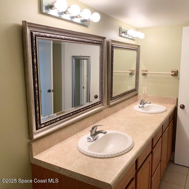 3060 North Atlantic Avenue, Unit 308 Cocoa Beach, FL 32931 - Photo 15 of 20 a bathroom with a sink and a mirror