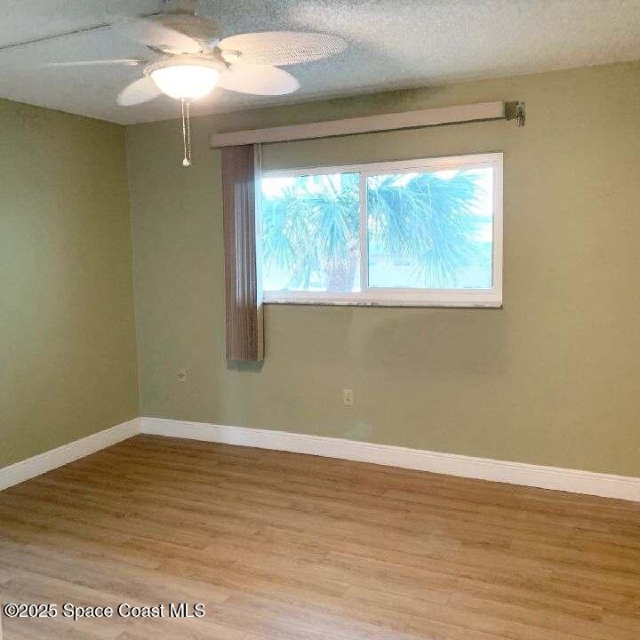 3060 North Atlantic Avenue, Unit 308 Cocoa Beach, FL 32931 - Photo 16 of 20 a view of a big room with wooden floor and windows