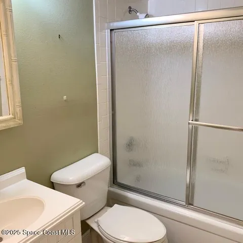 a white toilet sitting next to a bathroom sink