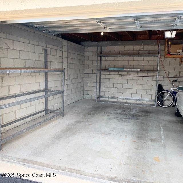 3060 North Atlantic Avenue, Unit 308 Cocoa Beach, FL 32931 - Photo 3 of 20 a view of a garage with wooden walls