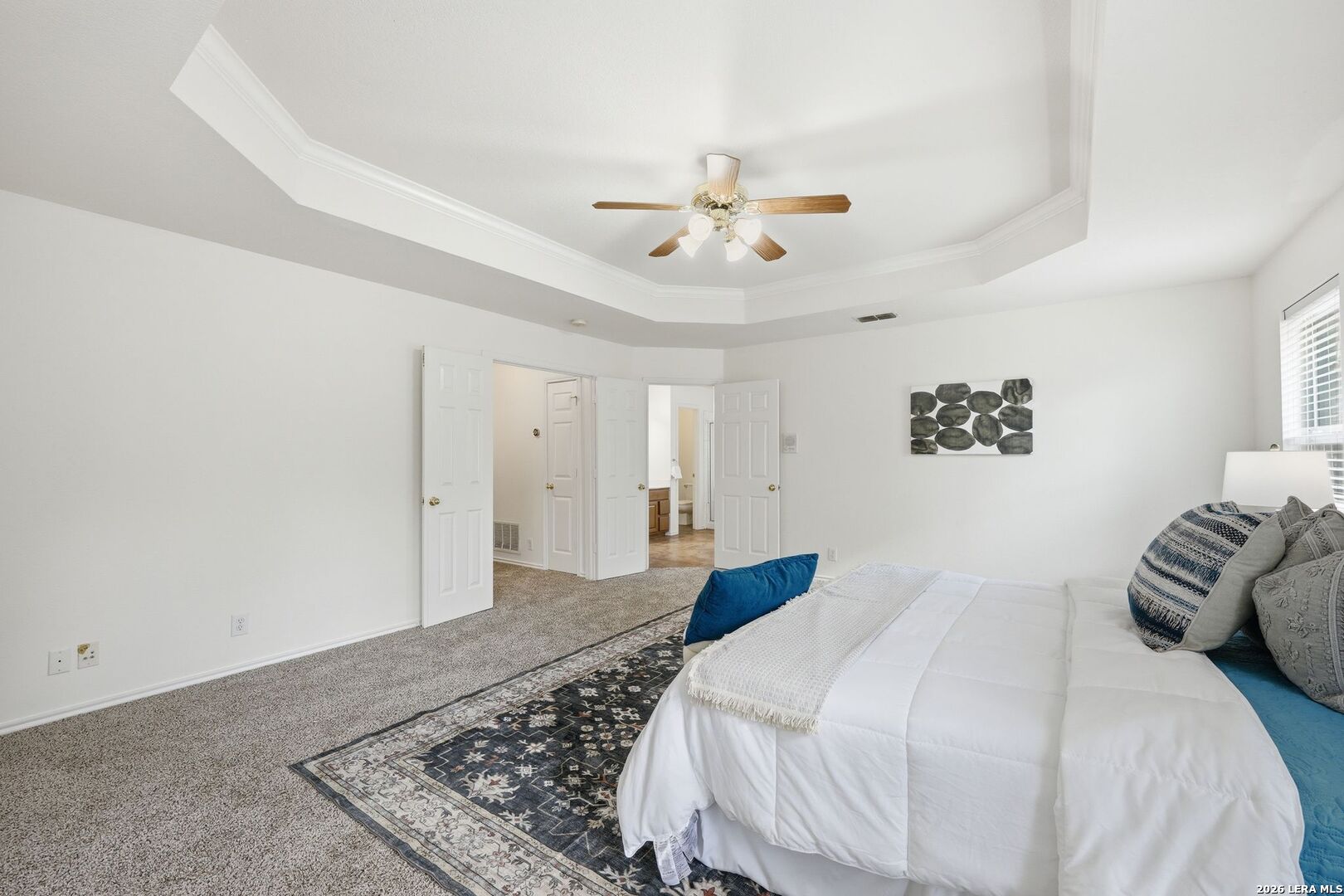 12910 Green Cedar Helotes, TX 78023 - Photo 26 of 65 a bedroom with a bed and a chandelier
