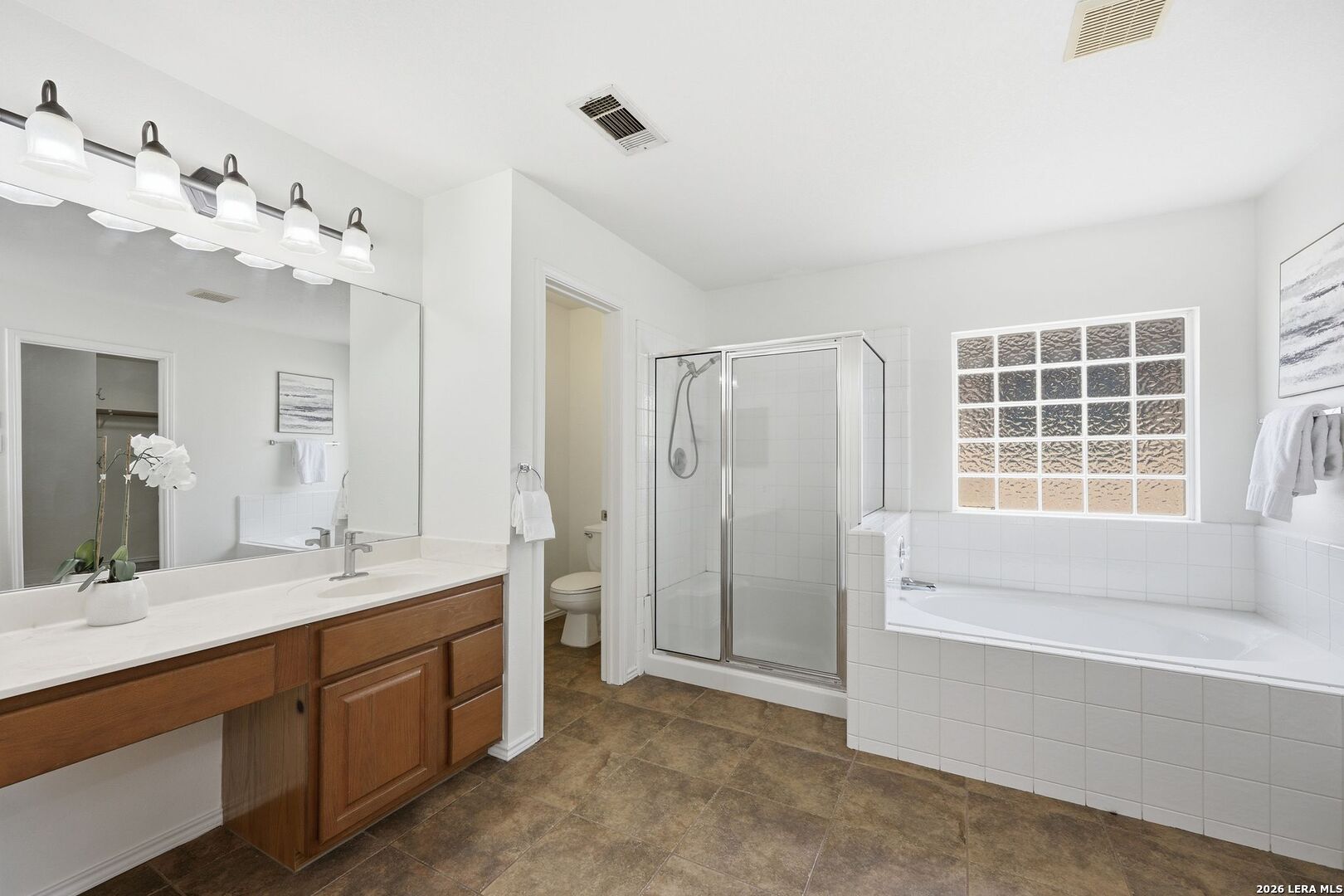 12910 Green Cedar Helotes, TX 78023 - Photo 31 of 65 a spacious bathroom with a tub sink and mirror
