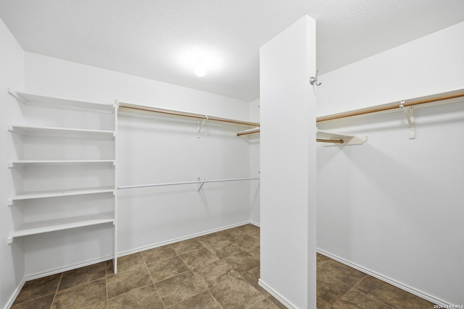 12910 Green Cedar Helotes, TX 78023 - Photo 35 of 65 a view of walk in closet with empty racks