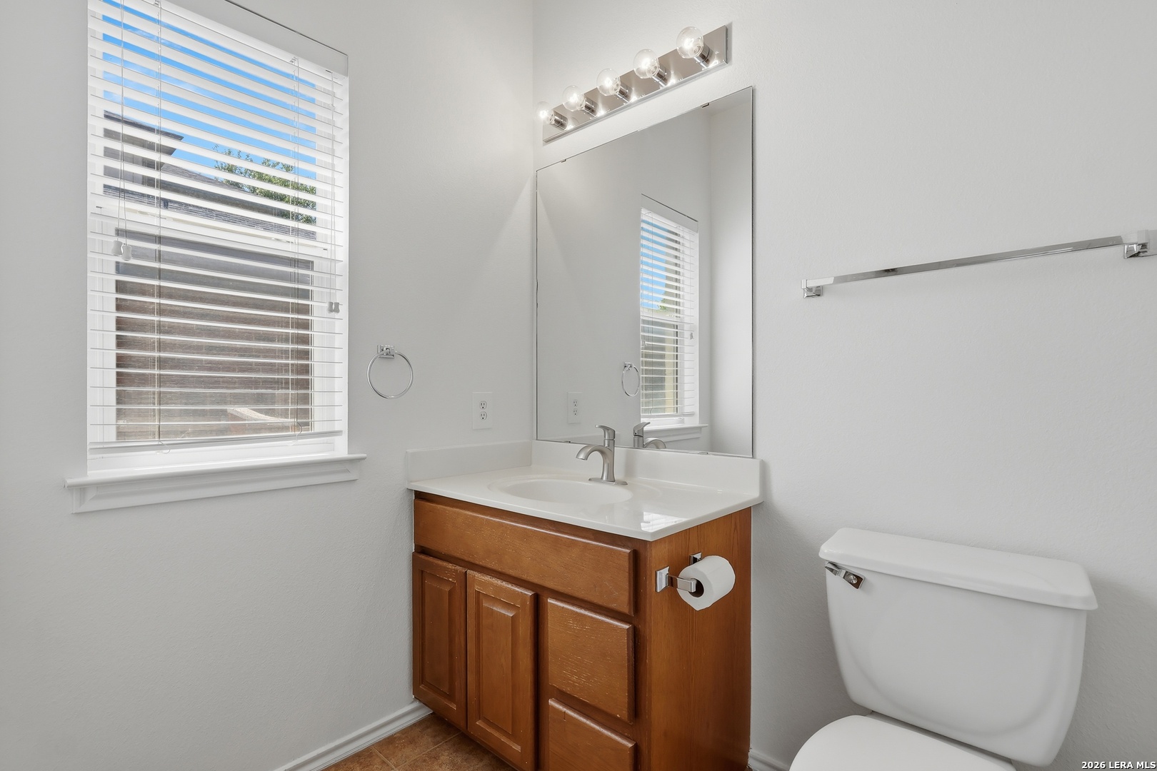 12910 Green Cedar Helotes, TX 78023 - Photo 40 of 65 a bathroom with a toilet a sink and a mirror