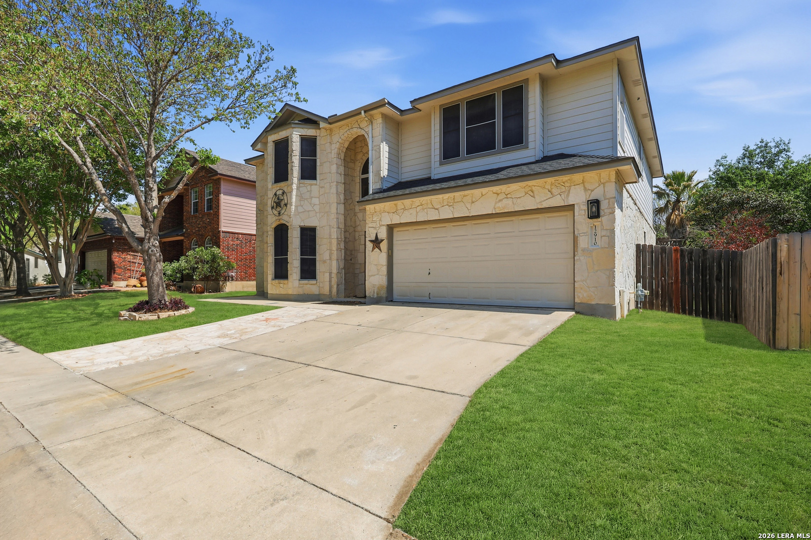 12910 Green Cedar Helotes, TX 78023 - Photo 4 of 65 a front view of a house with a yard and garage