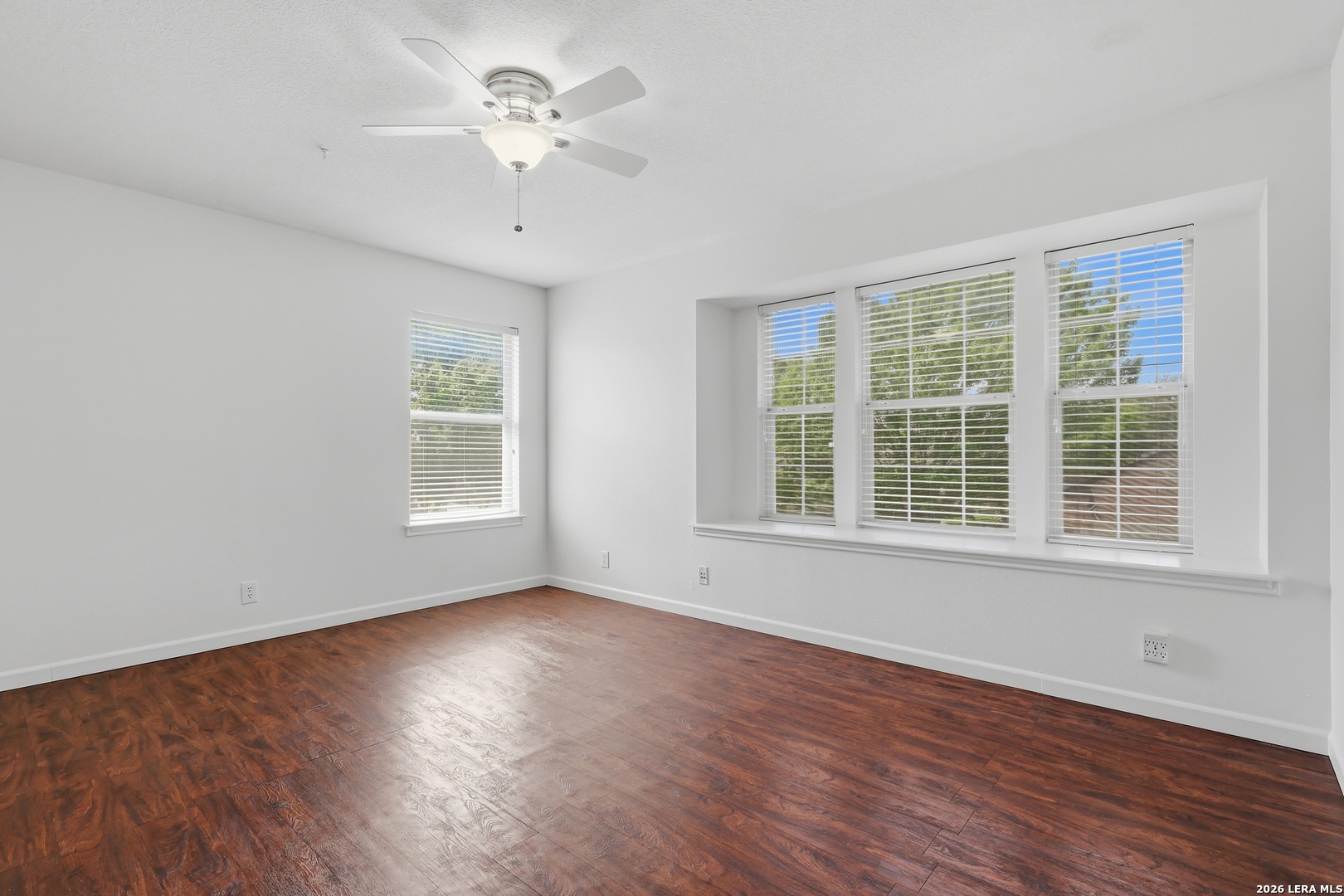12910 Green Cedar Helotes, TX 78023 - Photo 44 of 65 a view of an empty room with wooden floor and a window