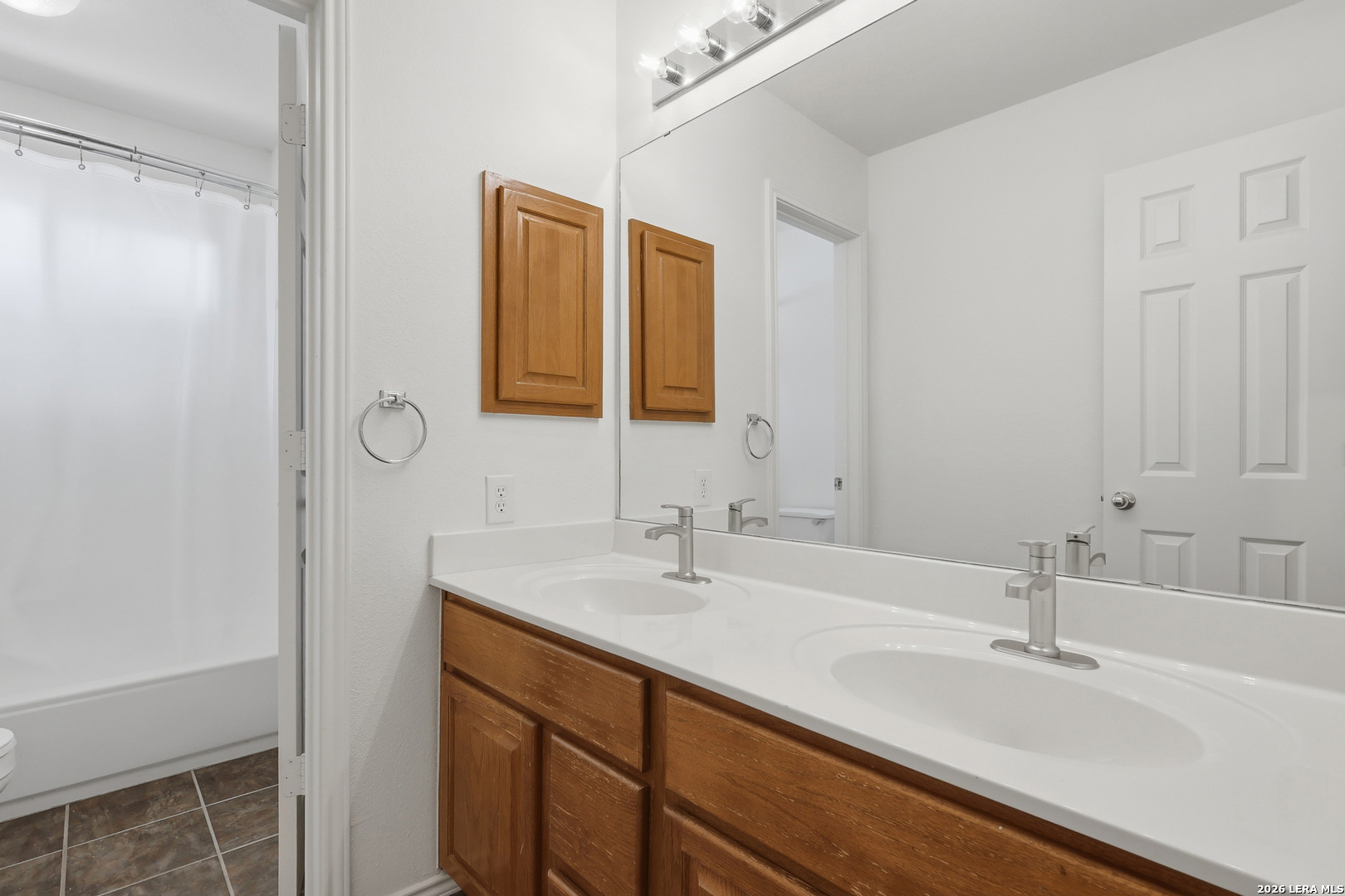 12910 Green Cedar Helotes, TX 78023 - Photo 46 of 65 a bathroom with a sink and a mirror