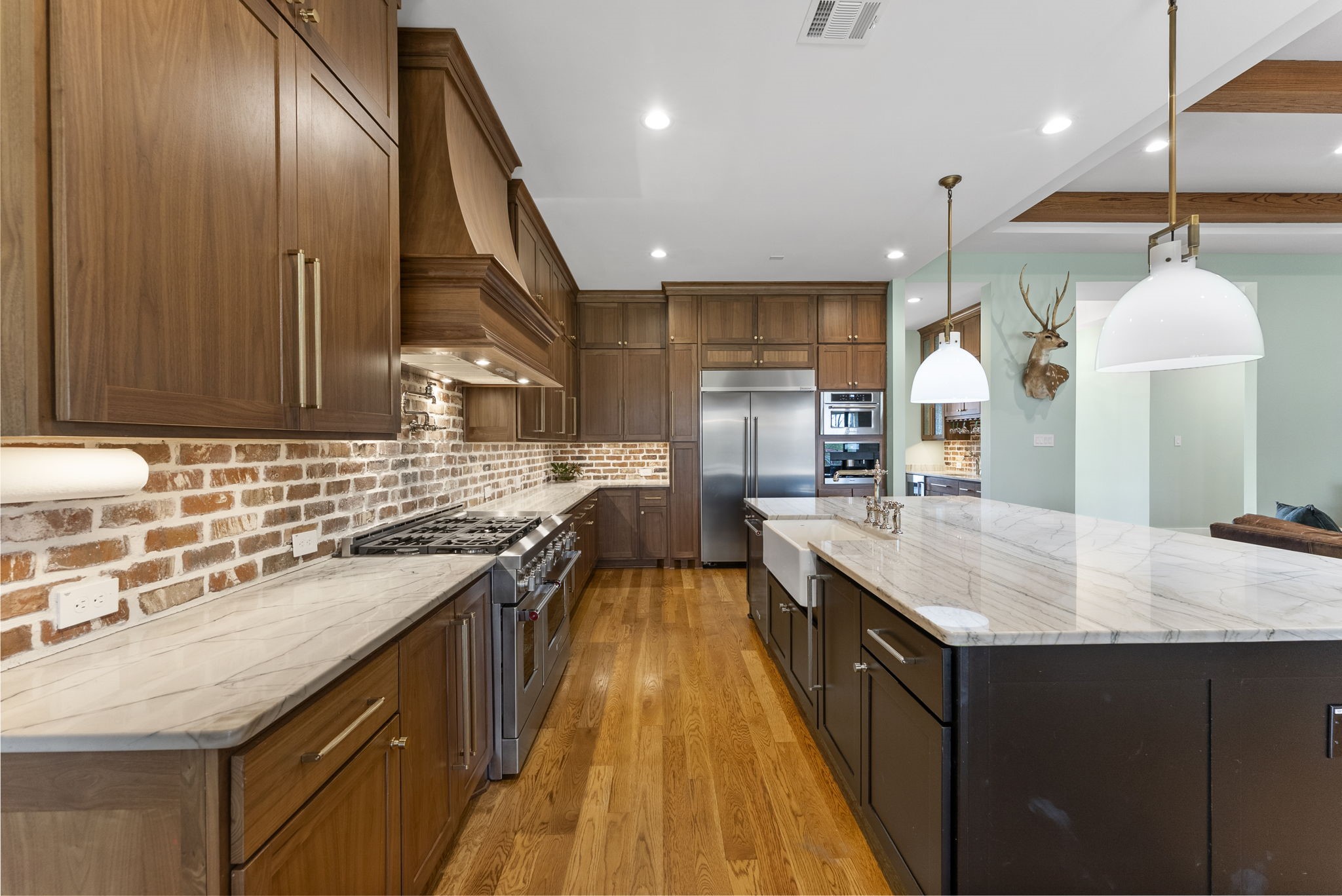 14019 Beartooth Bend Trail Conroe, TX 77384 - Photo 11 of 28 a kitchen with stainless steel appliances granite countertop sink stove and wooden cabinets