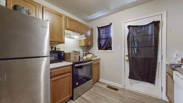 a kitchen with stainless steel appliances granite countertop a refrigerator and sink