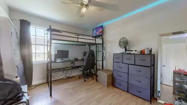 a view of a room with wooden floor