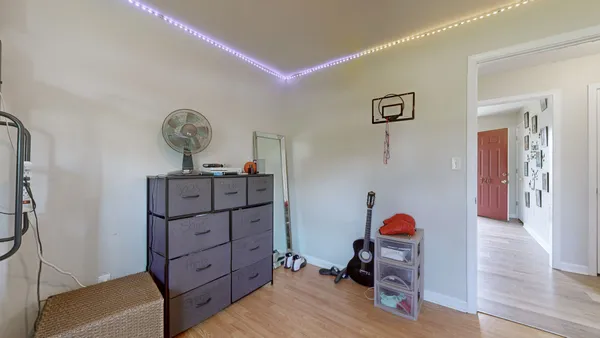 a bedroom with a bed and a chandelier